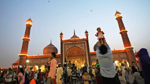 A Muslim man holds his son after his iftar (breaking of fast) meal during the holy month of Ramadan at the Jama Masjid (Grand Mosque) in the old quarters of Delhi, India, June 14, 2016. REUTERS/Adnan Abidi
